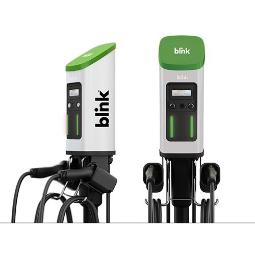 A white and green electric car charger next to each other.