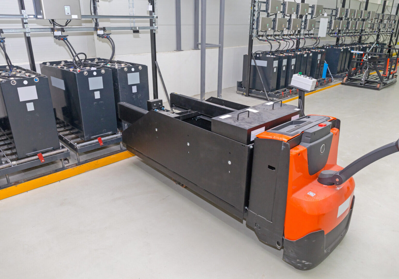 Pallet,Jack,Batteries,Cart,At,Industrial,Chargin,Station
